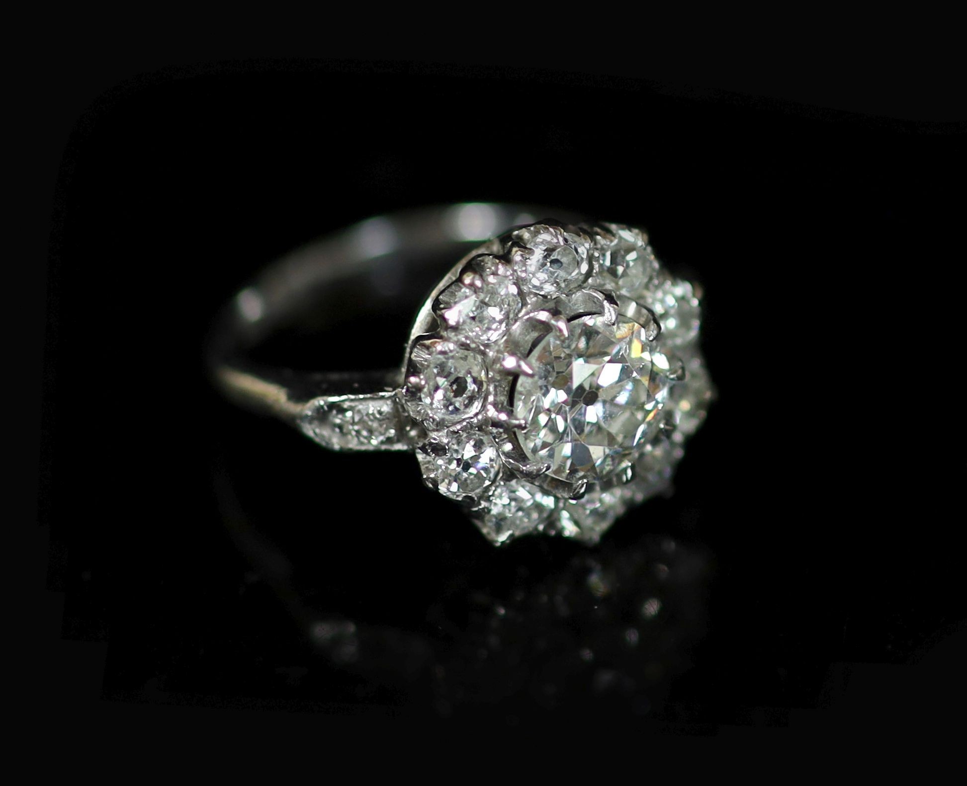 An 18ct white gold, platinum and diamond set cluster ring